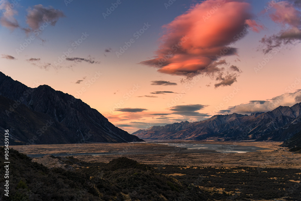 Sunrise over rocky mountain range on dry field in autumn Sunrise over rocky mountain range on dry field in autumn
