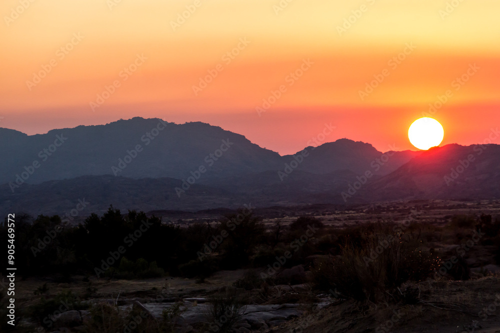A splendid colourful sunrise over the barren landscape of the Augrabies Falls National Park, with the mountains at Riemvasmaak in the background.