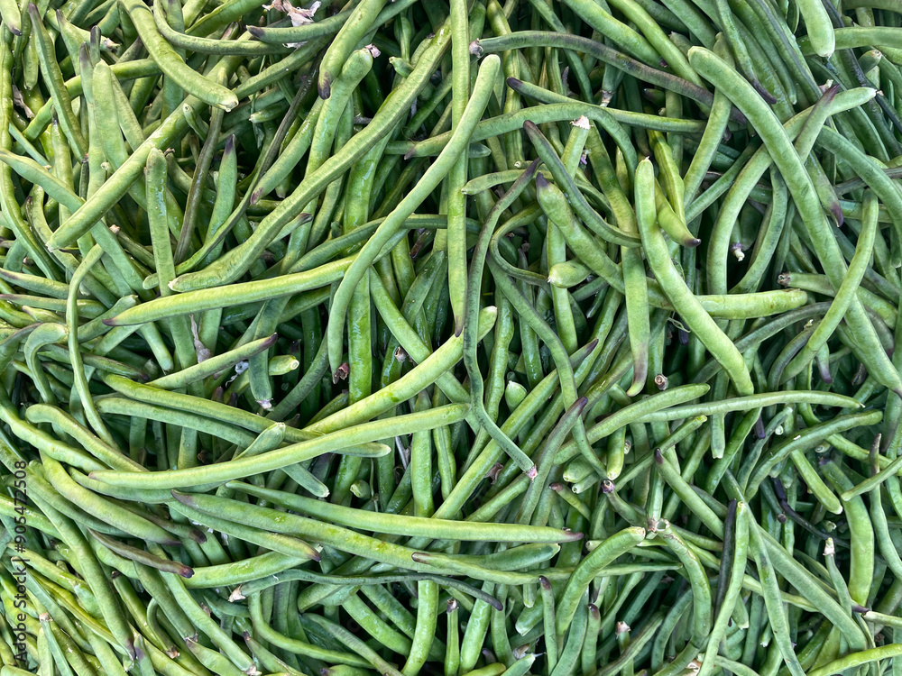 Green beans vegetable, top view background. Large amount of green beans in pods on market stall. Fresh green beans at farmers market in Greece. Healthy, vegetarian food. Green beans vegetable, top view background. Large amount of green beans in pods on market stall. Fresh green beans at farmers market in Greece. Healthy, vegetarian food.