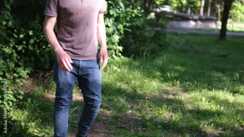 young man in gray shirt and blue jeans dances hip-hop energetically in green outdoor setting. lush foliage and sunlight create vibrant backdrop highlighting his expressive movements and relaxed style young man in gray shirt and blue jeans dances hip-hop energetically in green outdoor setting. lush foliage and sunlight create vibrant backdrop highlighting his expressive movements and relaxed style