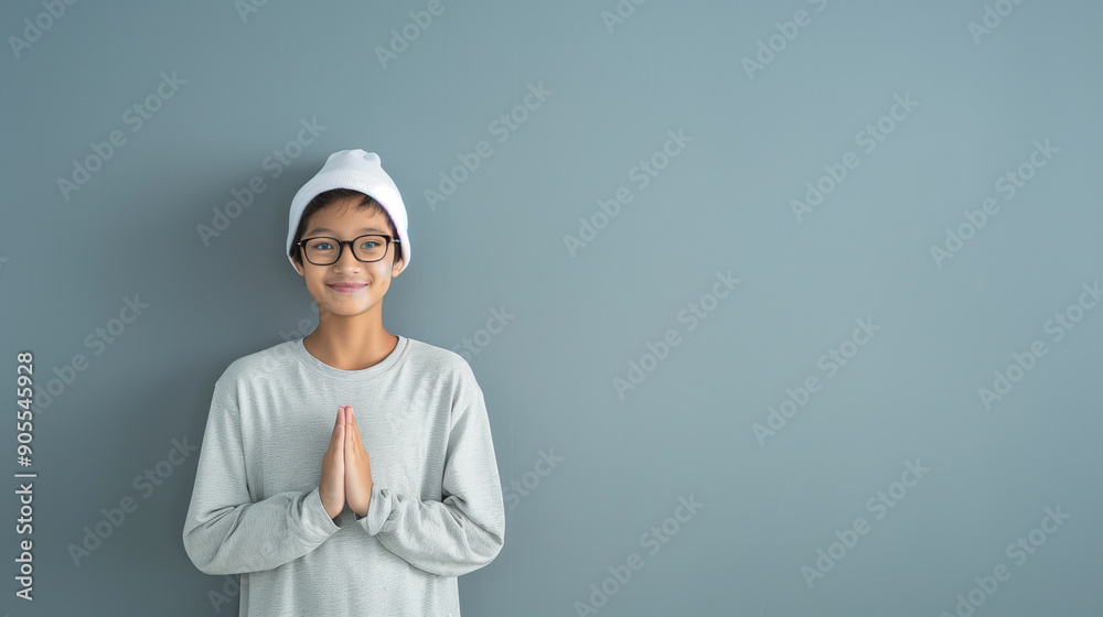 Indonesian Teenage muslim, smiling happily, hands namaste, koko shirts, gray trousers, white caps, white background