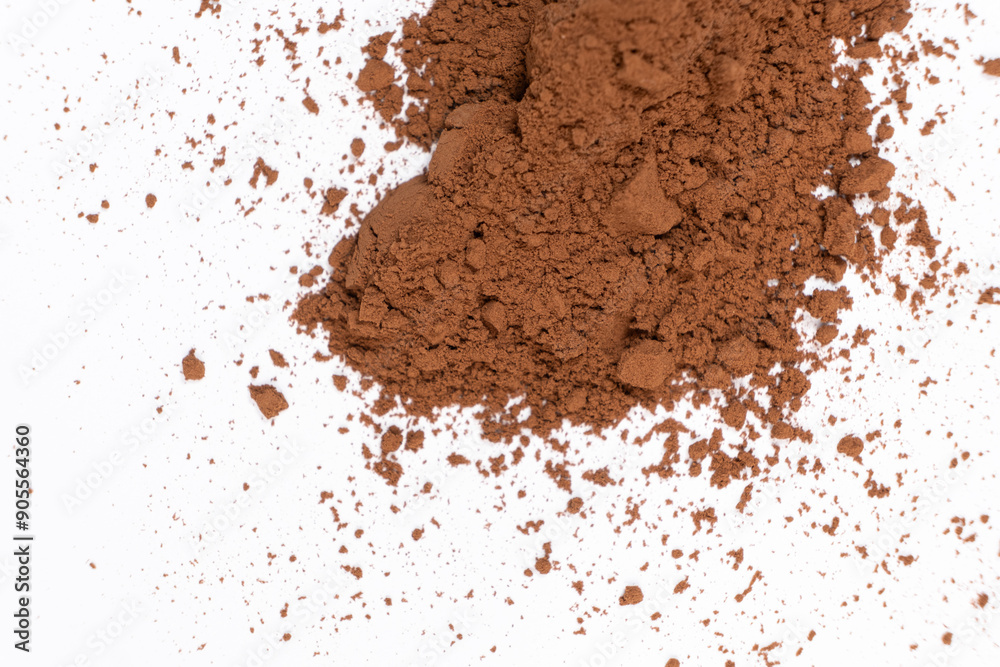 Cocoa powder scattered on white background close-up Cocoa powder scattered on white background close-up