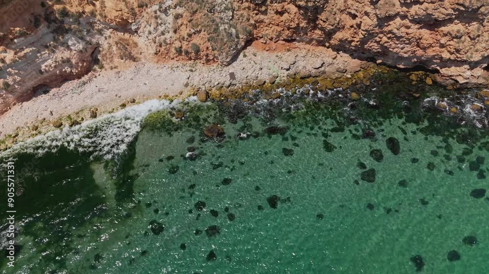 Aerial photograph shows the rugged coastline blending with the shimmering, crystalclear waters beautifully Aerial photograph shows the rugged coastline blending with the shimmering, crystalclear waters beautifully