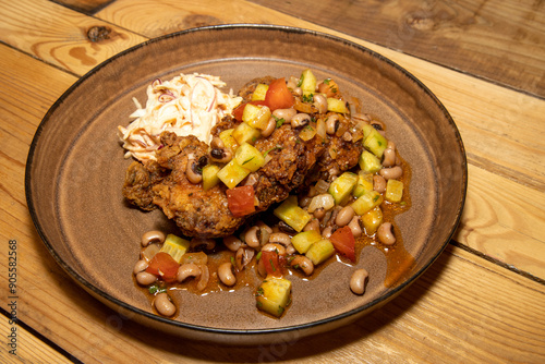 Obraz na płótnie A delicious plate of home made fried chicken with beans and cut vegetables on a wooden kitchen table w salonie