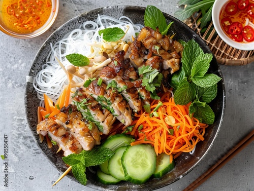 Bun Thit Nuong. The most popular Vietnamese dishes. Grilled pork served over vermicelli noodles with fresh vegetables and a fish sauce dressing. photo