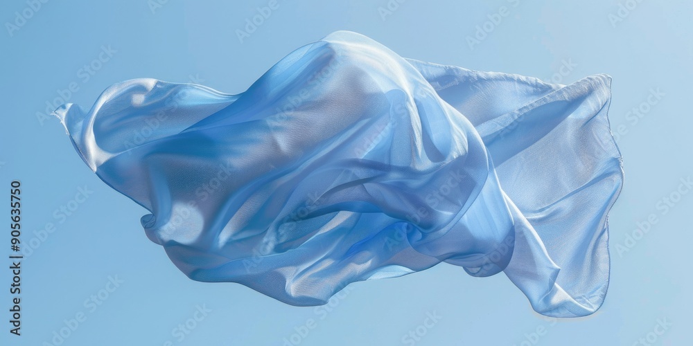 Fototapeta premium A blue and white fabric is floating in the air. Concept of freedom and lightness, as the fabric appears to be weightless and untethered. The blue and white colors create a calming