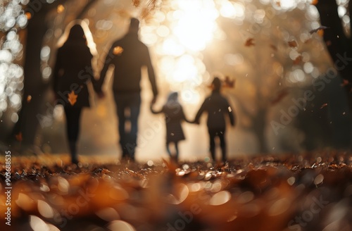 Family Walk During Autumn Sunset in a Leaf-Covered Trail