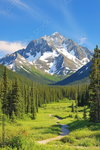 Majestic snow-capped mountain overlooking lush green valley under bright blue sky