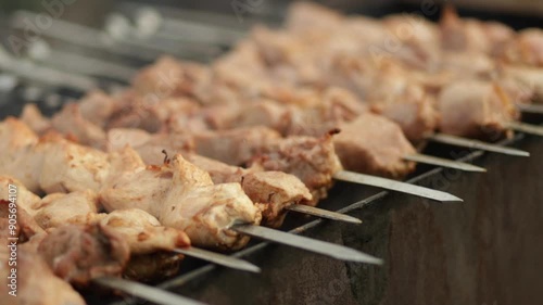 Frying kebab on the skewers on brazier. Meat pork and poultry