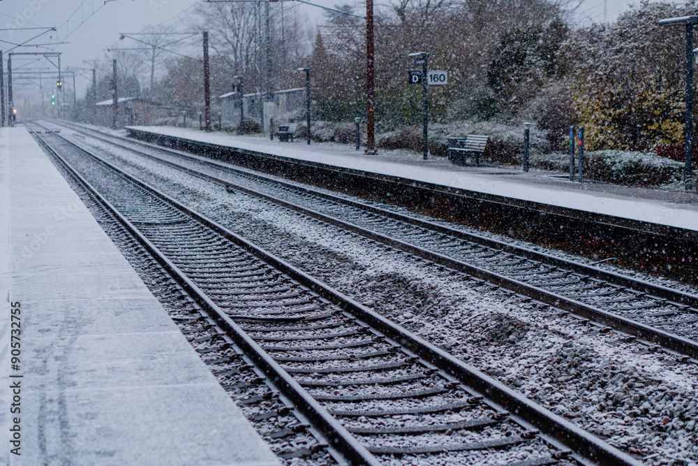 Railway. A train approaches the station on a winter day. Railway. A train approaches the station on a winter day.