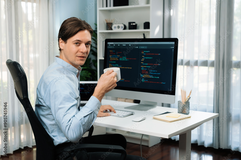 IT developer looking camera with holding coffee cup with online software on pc and laptop monitor beside, coding program on updated version application project creating new code system. Pecuniary. IT developer looking camera with holding coffee cup with online software on pc and laptop monitor beside, coding program on updated version application project creating new code system. Pecuniary.