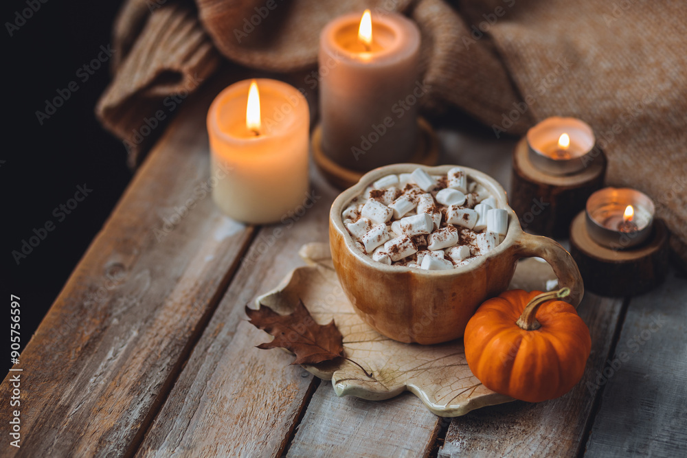 Spicy sweet fall hot drink: delicious pumpkin latte with cinnamon, marshmallow with salted caramel. Served in handmade artisan mug in shape of pumpkins, cozy home decor with candles, dry autumn leaves Spicy sweet fall hot drink: delicious pumpkin latte with cinnamon, marshmallow with salted caramel. Served in handmade artisan mug in shape of pumpkins, cozy home decor with candles, dry autumn leaves