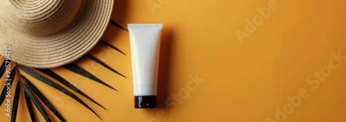 Sun Care Essentials With Straw Hat and Green Leaf on Vibrant Orange Background