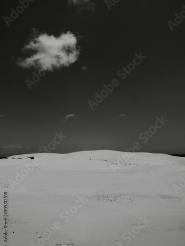 Lonely cloud above sand dunes