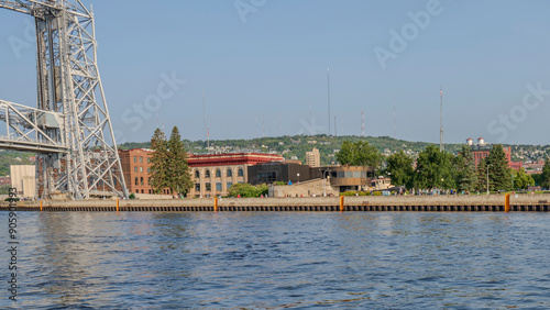 The North Pier pedestrian walkway along the Duluth Harbor entrance with Ariel Lift Bridge and Corp of Engineers building photo