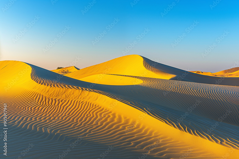An enchanting view of golden sand dunes under a clear blue sky ...