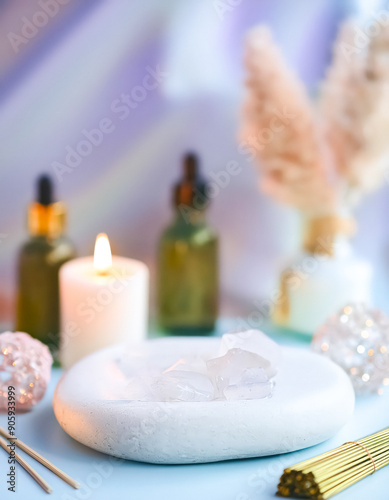 Clear Quartz Crystal On White Stone With Essential Oils And Candle