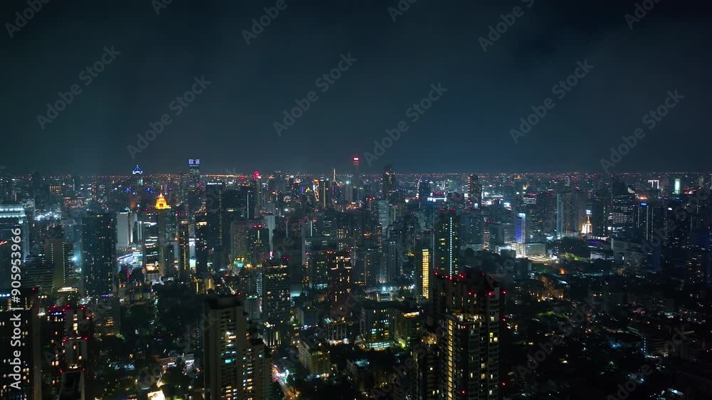 Thailand Bangkok Aerial. Night time illumination flight over Bangkok city downtown traffic street crossroad aerial topdown. Thailand Bangkok Aerial. Night time illumination flight over Bangkok city downtown traffic street crossroad aerial topdown.