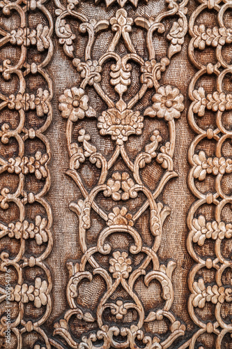 oriental flower pattern Uzbek ornament on wooden carved door in Tashkent in Uzbekistan close-up photo