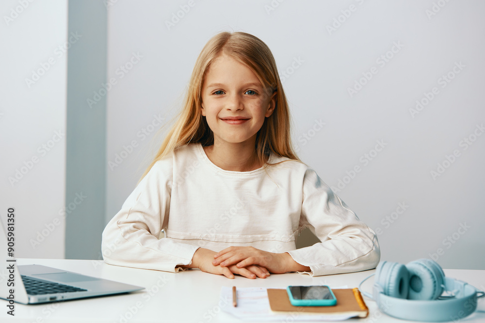 Smiling girl using laptop for elearning at home A cute teenage girl is happily sitting at her desk, surrounded by books and notebooks With a big smile on her face, she wears headphones while typing on Smiling girl using laptop for elearning at home A cute teenage girl is happily sitting at her desk, surrounded by books and notebooks With a big smile on her face, she wears headphones while typing on