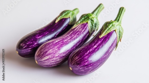 Wallpaper Mural Close-up of two fresh, vibrant purple eggplants on a white background, ideal for culinary and agricultural themes. Torontodigital.ca