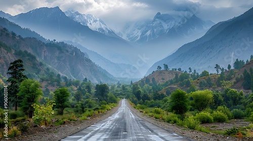 road through a valley with majestic mountains in the distance