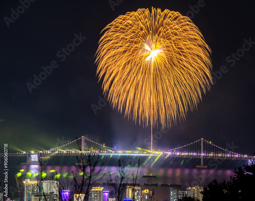 Suyeong-gu, Busan, South Korea - December 17, 2022: High angle and night view of fireworks and laser show on Gwangan Bridge and sea at Gwangalli
 photo