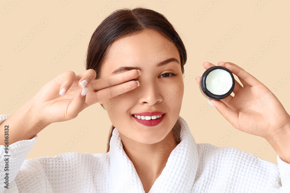 Pretty young woman with jar of facial cream on beige background Pretty young woman with jar of facial cream on beige background