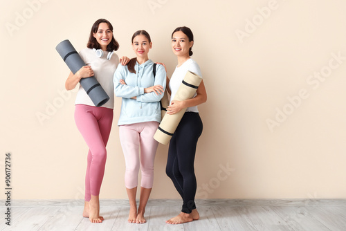 Sporty young women with yog...