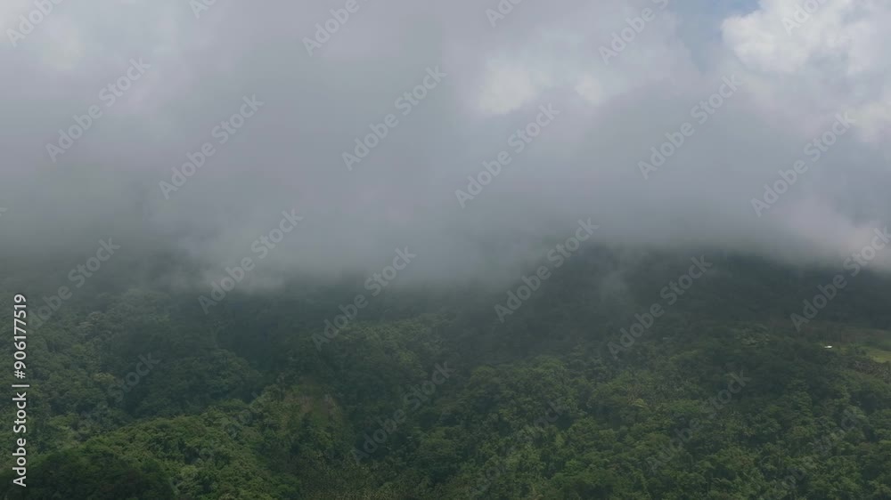 Green mountain with trees covered by fogs in Camiguin Island. Philippines.