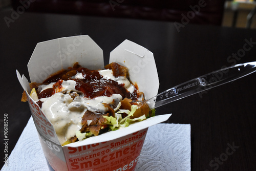 Tasty kebab in a box with a fork