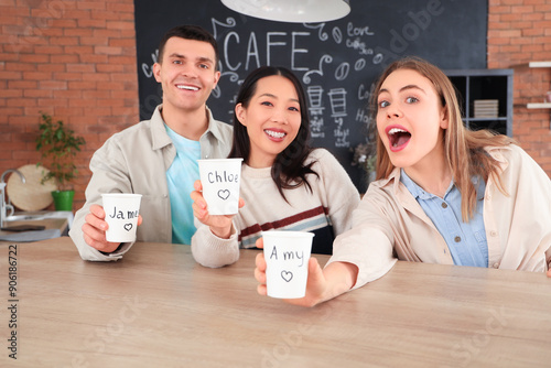 Young friends with cups at ...