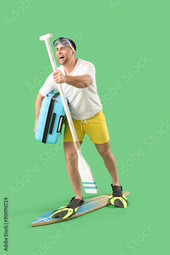 Male tourist with suitcase ...