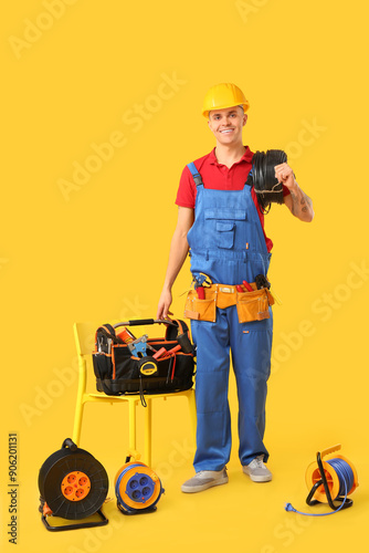 Young male electrician with...