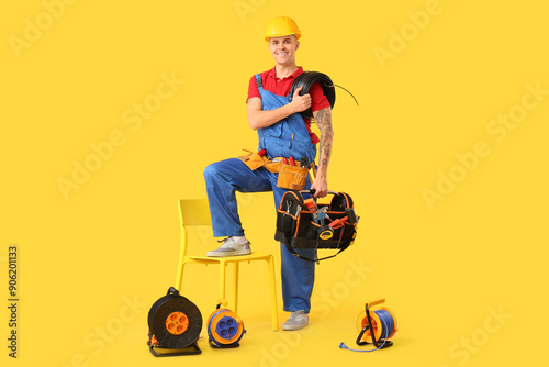 Young male electrician with...