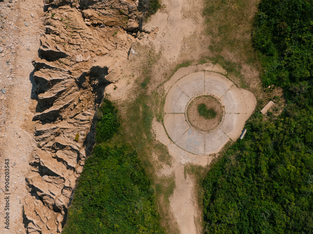 Aerial View of Circular Structure and Rugged Terrain
Aerial View of Circular Structure and Rugged Terrain