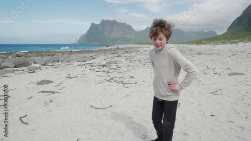 Cute boy walks on Uttakleiv, Beach in Norway Lofoten photo