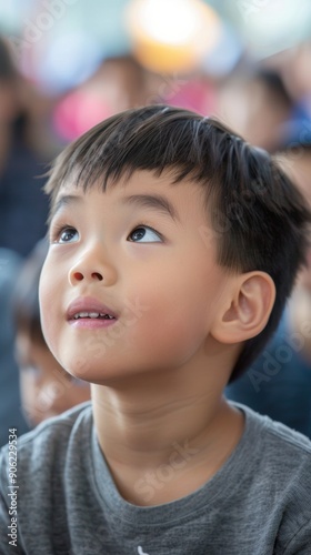 A young boy looks upward with wonder as he observes an outdoor event filled with excitement