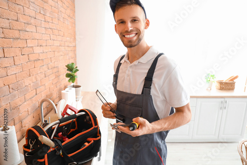 Smiling young plumber or ha...