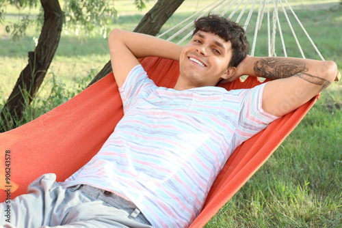 Young man resting in hammoc...