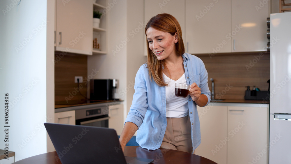 Young woman working online at her home office and enjoying coffee Young woman working online at her home office and enjoying coffee