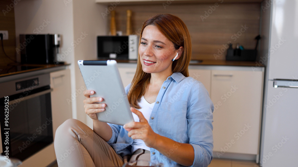 Beautiful woman relaxing at home and using a digital tablet Beautiful woman relaxing at home and using a digital tablet