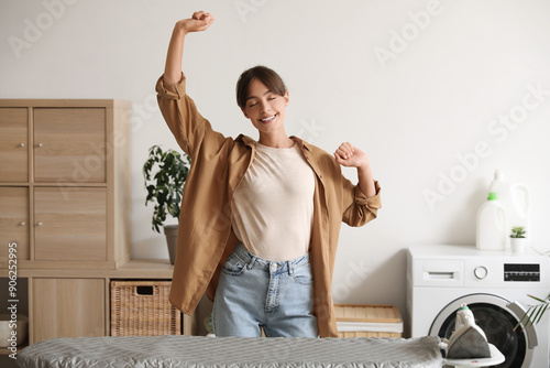 Happy young woman dancing i...