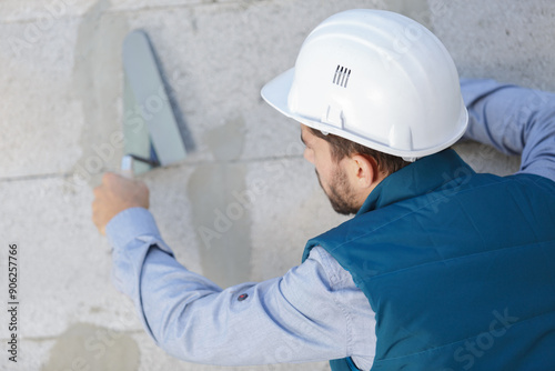 a tecnician plastering exterior wall