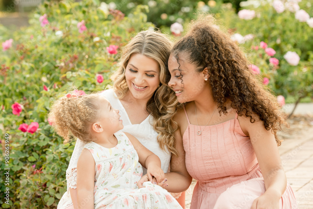 Mother with biracial daughters in garden Mother with biracial daughters in garden