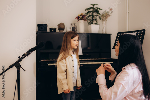 Canvas Print Vocal school. a woman teaches a little girl to sing