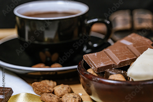 Chocolate chip cookies, dark and white chocolate bar, small bowl of oatmeal and nuts. International Chocolate Day.