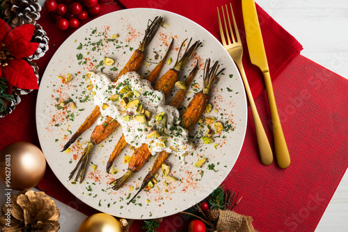 Oven roasted carrots with Italian burrata and pistachios on a christmas table.
