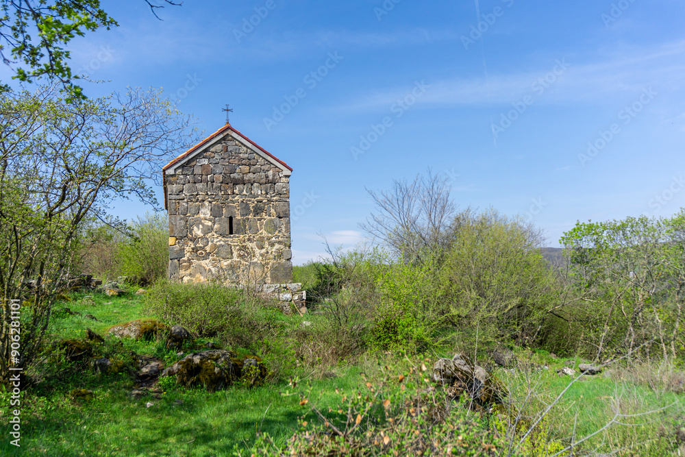 A small medieval church. Tiled roof, stone walls. A meadow of green grass, bushes and trees. Samshvilde A small medieval church. Tiled roof, stone walls. A meadow of green grass, bushes and trees. Samshvilde