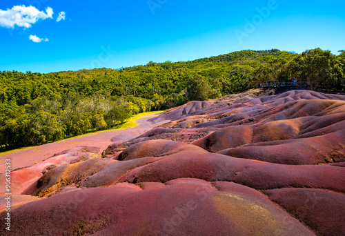 The “Seven Coloured Earths“ are a geological formation and tourist attraction in the Chamarel plain of the Rivière Noire District in Mauritius. Sand in red, brown, violet, green, blue, purple, yellow. photo